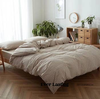 the duvet cover in brown on a bed