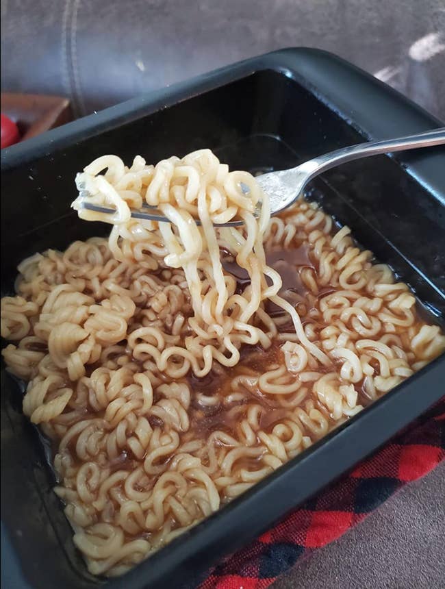 Reviewer's cooked ramen in a square silicone cooker 