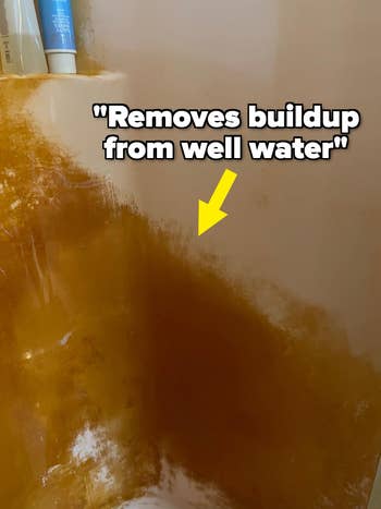 Close-up of a ablution  with rust stains and a substance   supra  stating 