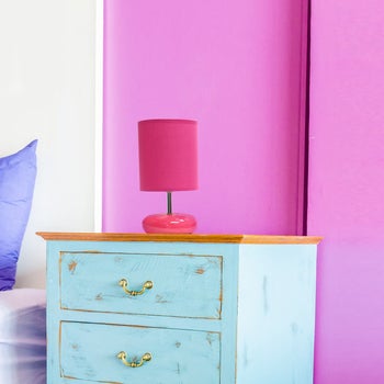 lifestyle image of pink lamp with pink shade on a nightstand