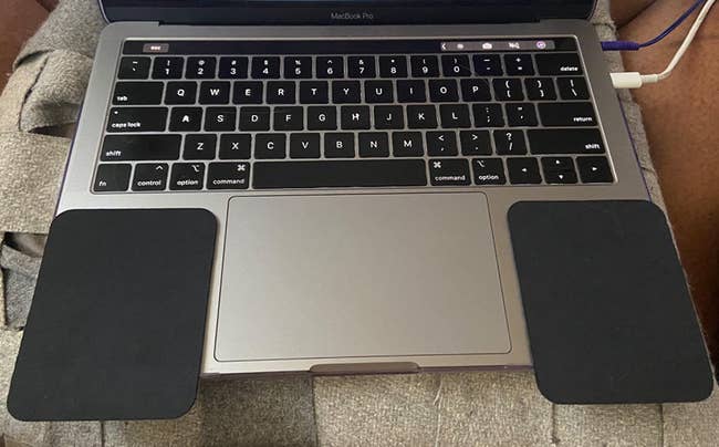 reviewer pic of the black wrist pads placed on both sides of Macbook touchpad