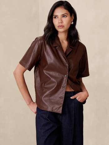 A model in the brown shirt buttoned
