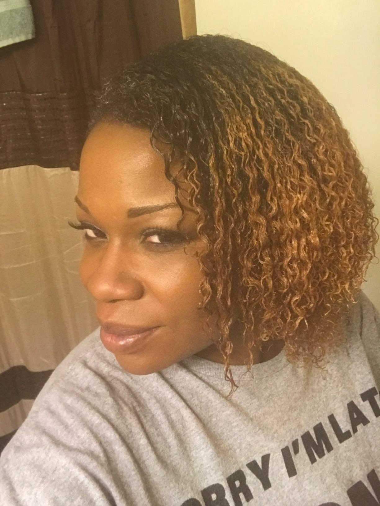 a reviewer showing their curly hair after using the brush