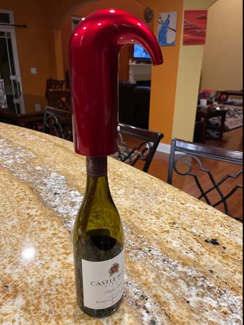 red wine aerating device strapped to a wine bottle top 