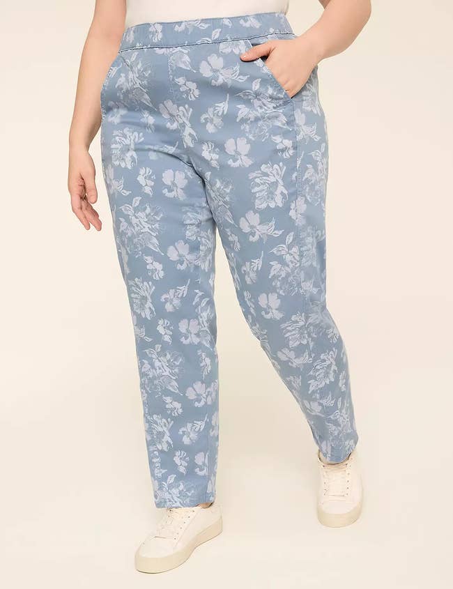 Model wearing floral print pants with pockets and white sneakers