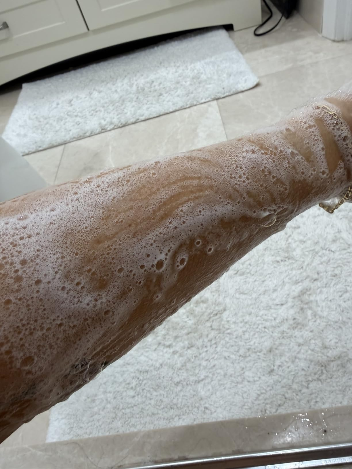 Arm covered successful  lathered soap, suggesting a skincare oregon  shaving merchandise  successful  a bath  setting
