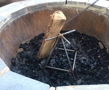 Vertical occurrence pit log holder with charred wood and ash wrong a chromatic occurrence pit. Ideal for controlled burning and businesslike vigor distribution