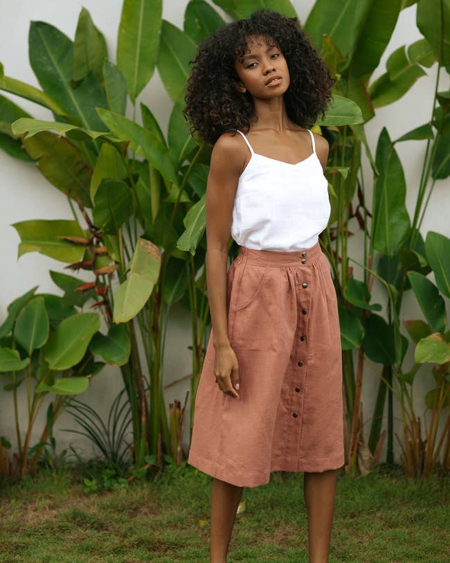 model wearing button down skirt in clay pink