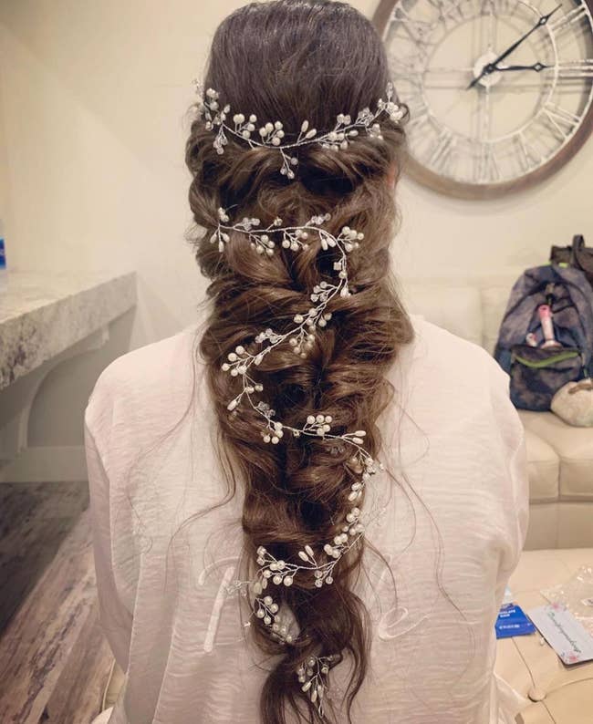 Reviewer with a very thick braid hairstyle and the extra long vine placed down the braid