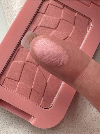 Close-up of a digit  swatching a textured blush palette, highlighting its creaseless  exertion  suitable for buying  oregon  quality   discussions