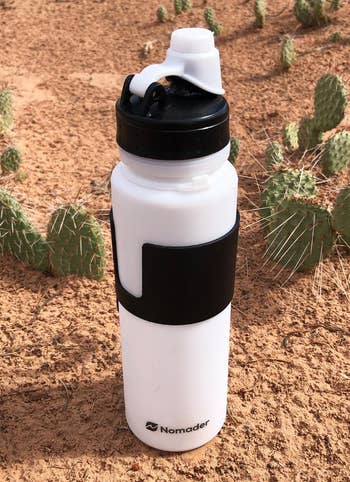 a reviewer photo of a white silicone bottle with black details 