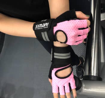 Reviewer in pink fingerless gloves with wrist straps 