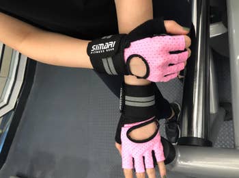 Reviewer in pink fingerless gloves with wrist straps 