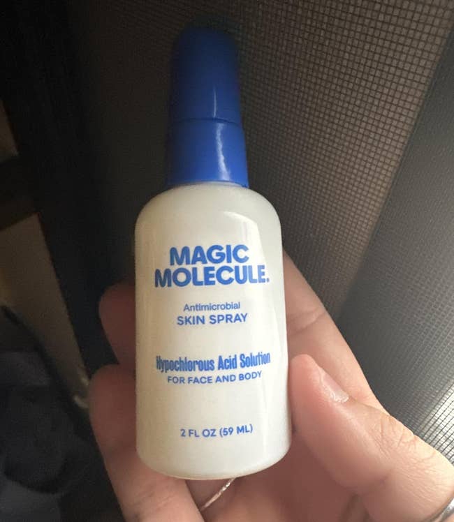A manus holds a 2 fl oz vessel of