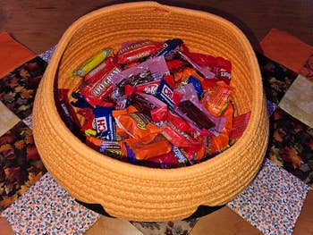 Halloween-themed handbasket  filled with assorted candy