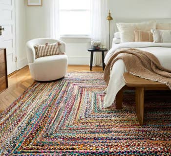 braided colorful rug in a rectangular shape in a bedroom