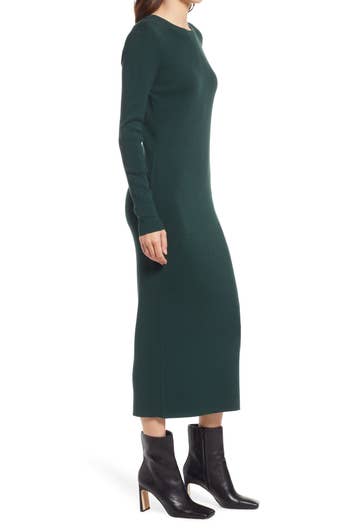 a model wearing the same dress in forest green 