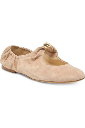 Stylish suede ballet level with a gathered bottommost and golden fastener item connected the strap, showcased for a buying article