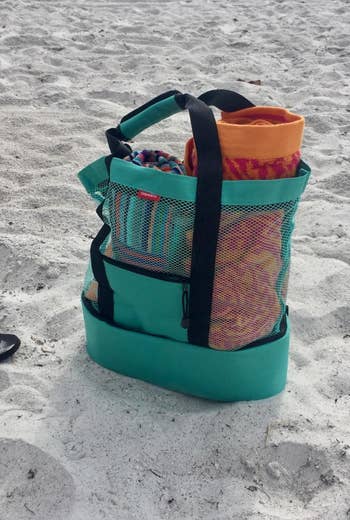 teal cooler bag on a beach