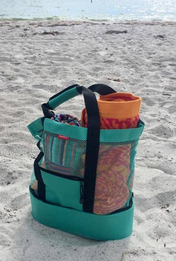 teal cooler bag on a beach