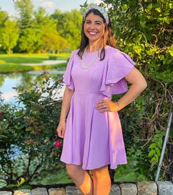reviewer wearing the purple dress