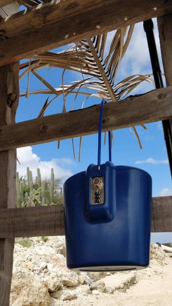 reviewer's blue portable safe locked on a cabana