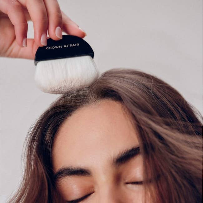 Someone applying the pulverization to their scalp