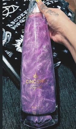 purple glitter in bottle of alcohol