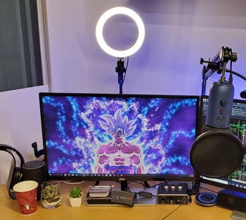 the ring light set up behind a reviewer's desk setup