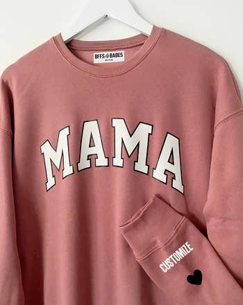 a pink sweatshirt that says 