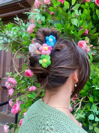 the blue, pink, and green floral hair clip in a model's hair
