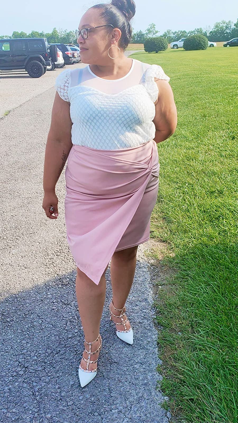 Reviewer is wearing a white top and light pink wrap pencil skirt