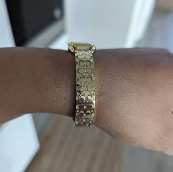 same reviewer with their wrist turned to amusement Coach monogram logo
