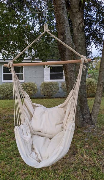 reviewer image of the hammock chair hung from a tree