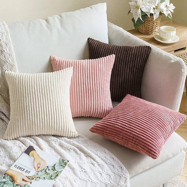 four corduroy pillows on a couch