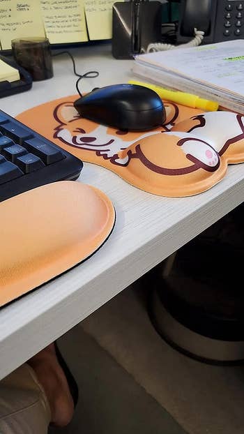 reviewer photo of corgi butt mouse pad with mouse on it