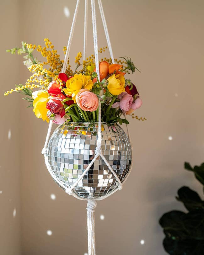 hanging disco ball planter with flowers in it