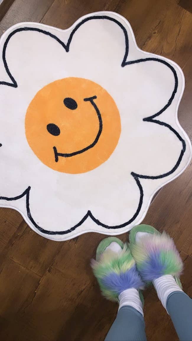 a reviewer's flower shaped rug with a smiley face in between