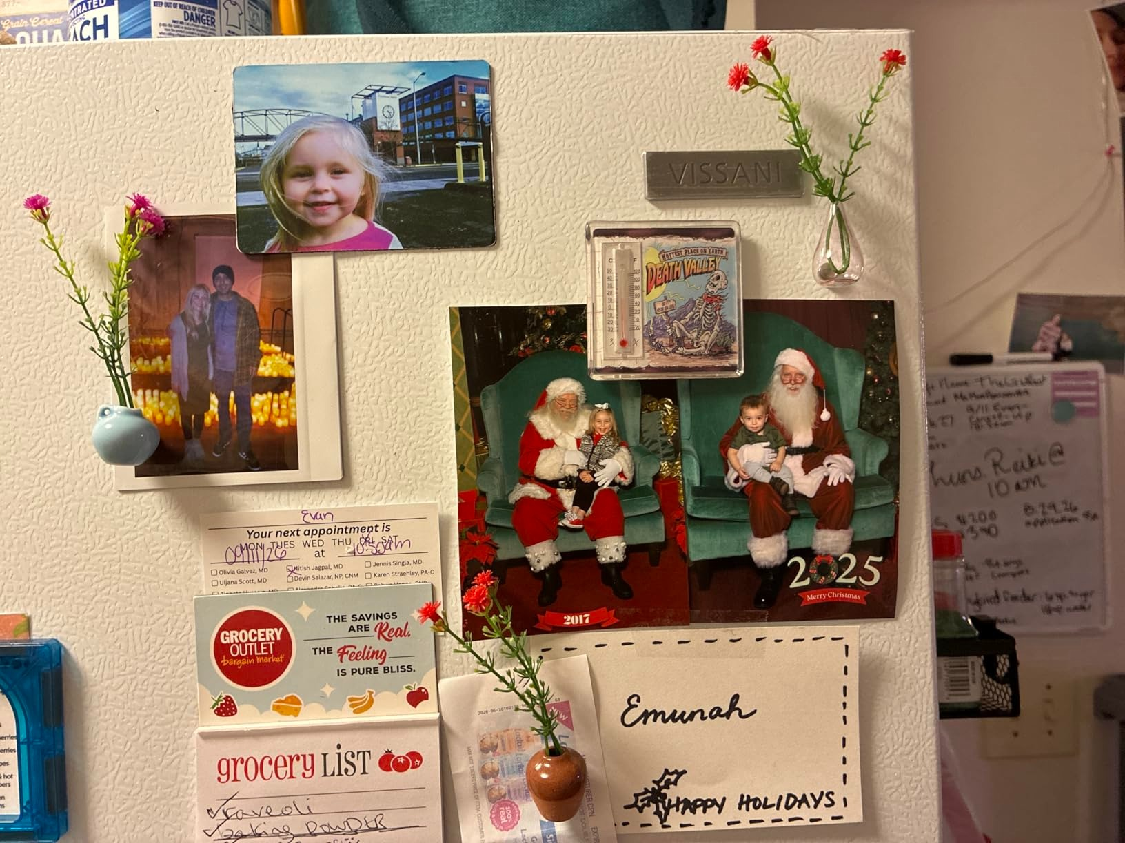 Refrigerator with household  photos, vacation  paper  featuring Santa, and market  list