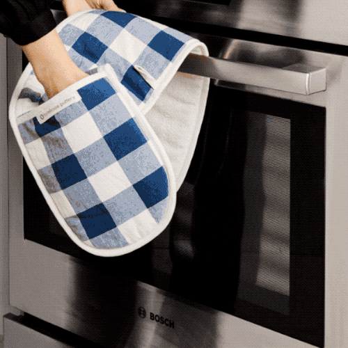 gif of a model pulling a pie from the oven using the blue gingham oven mitt