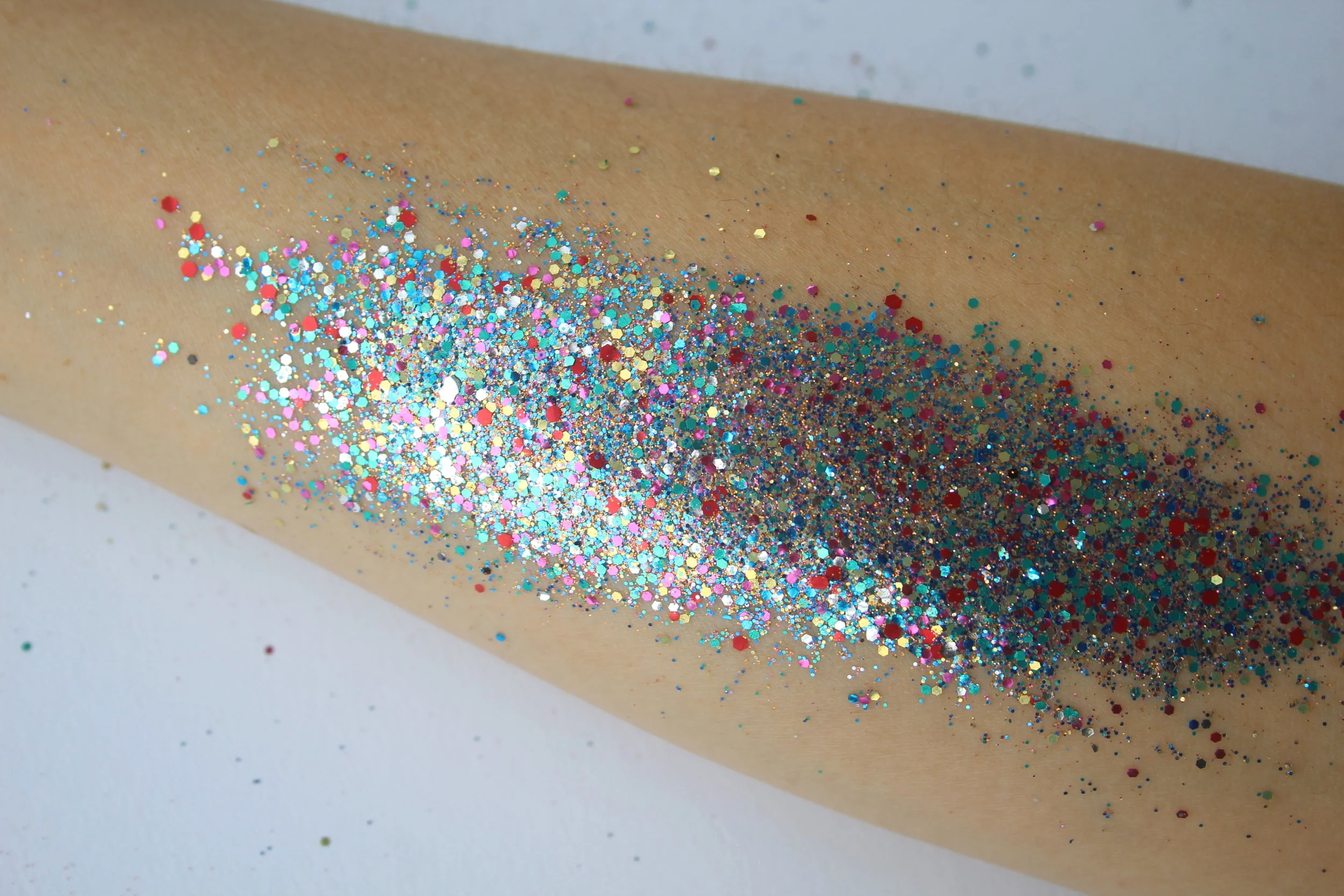 Glitter sprinkled connected  an arm, showcasing a vibrant and festive look