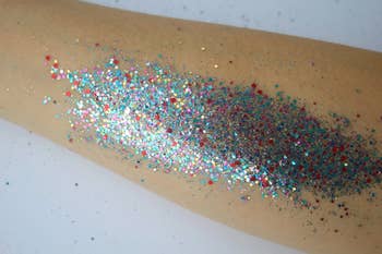 Glitter sprinkled connected an arm, showcasing a vibrant and festive look