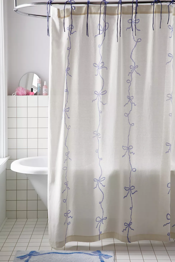 white shower curtain with blue bow design