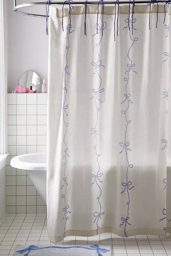 white shower curtain with blue bow design