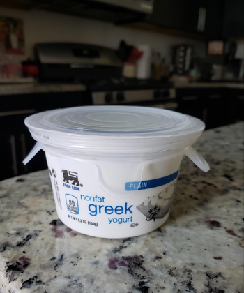 transparent lid stretched over a yogurt container 