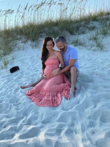 reviewer posing in coral maxi dress with partner
