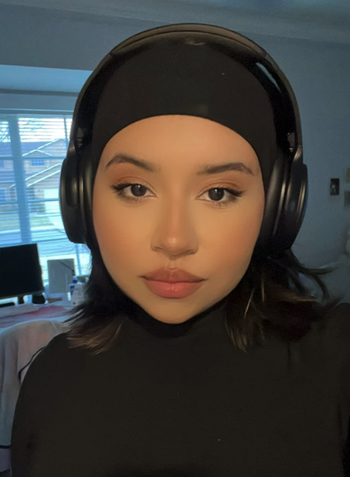 reviewer wearing headphones in black