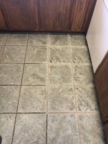 on left, dirty grout and on right, cleaner grout after using the oscillating mini power scrubber