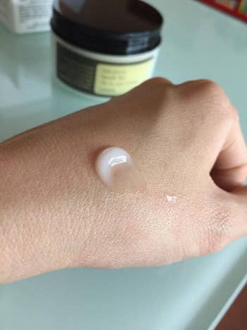 reviewer with moisturizing on their hand