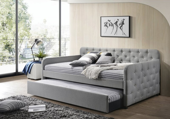 lifestyle image of gray upholstered daybed with trundle